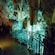Stalactite formations inside a large cave with a walkway